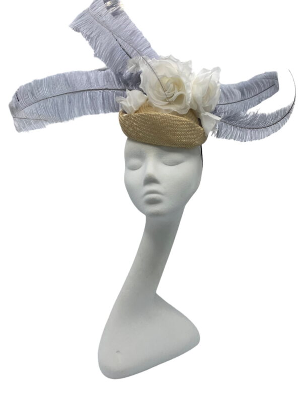 Cream/beige base with an ivory flower surrounded with an array of large silver/grey feathers.